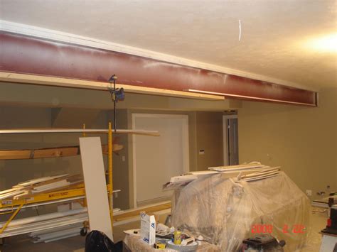 boxing in a steel beam|covering steel beam with board.